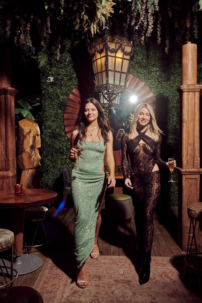 Guests arriving at Opium Lounge through the lantern-lit interior