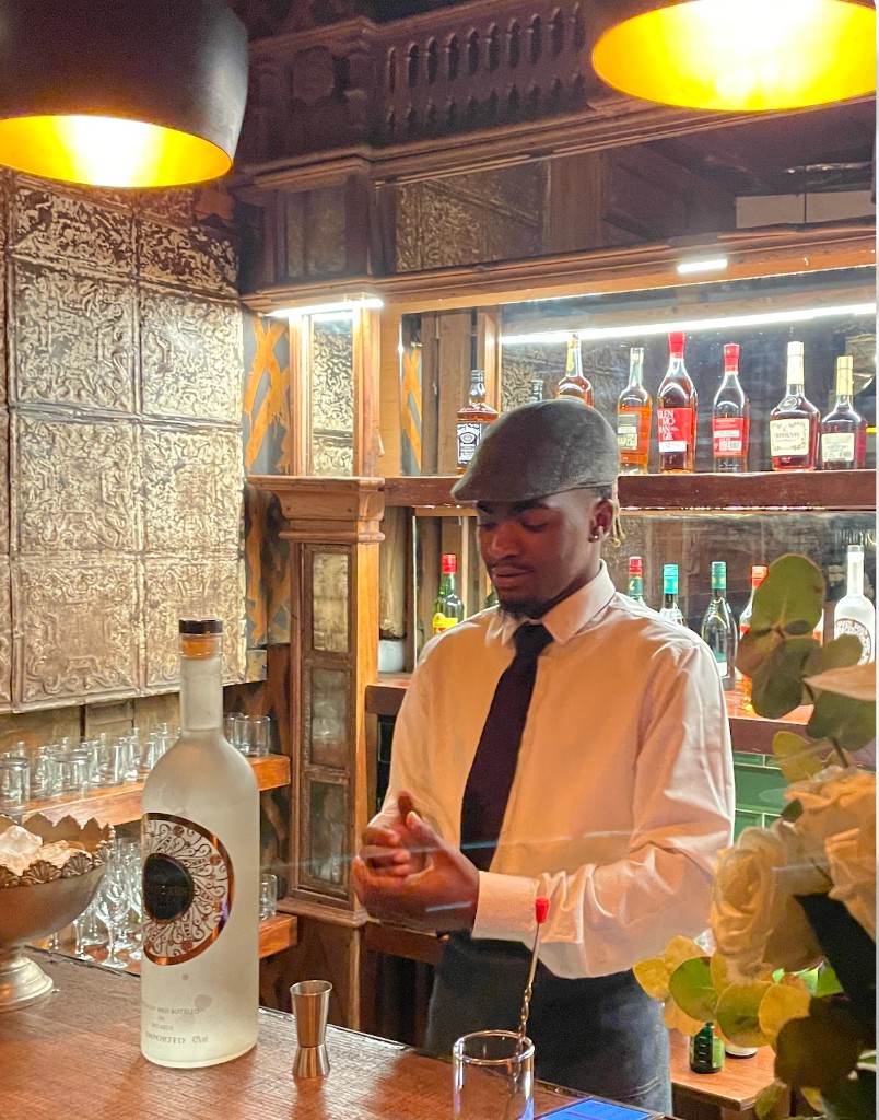 The Alligator Bar — bartender crafting a signature cocktail