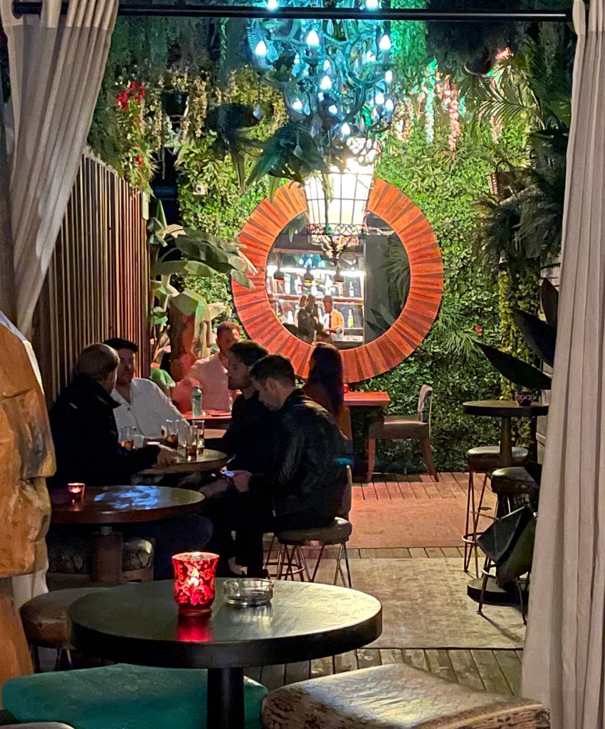 The Champagne Garden — candlelit courtyard with living green walls