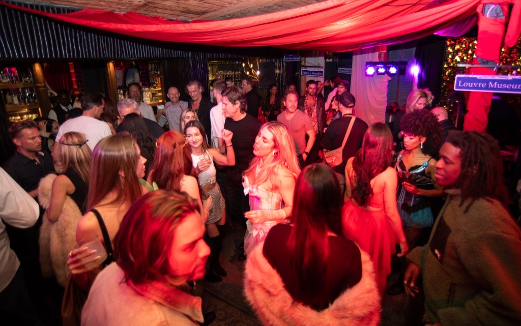 Packed lounge with neon rope ceiling