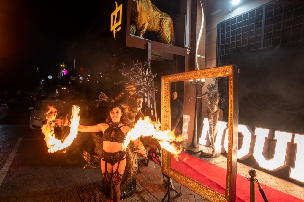 Fire performer at Opium entrance — red carpet production